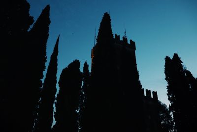 Low angle view of silhouette building against sky