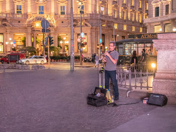 People on illuminated street at night