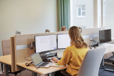 Woman using computer in office