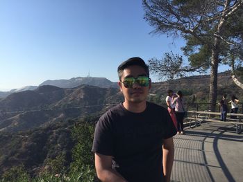 Man standing by mountain against clear sky