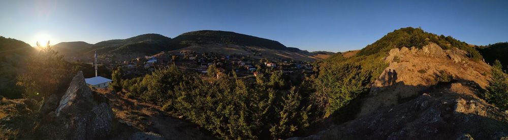 Panoramic shot of people on mountain against sky