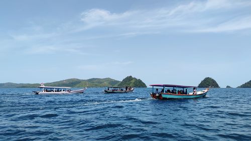 Boat sailing in sea against sky