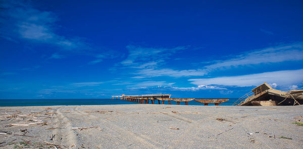 Scenic view of beach against blue sky