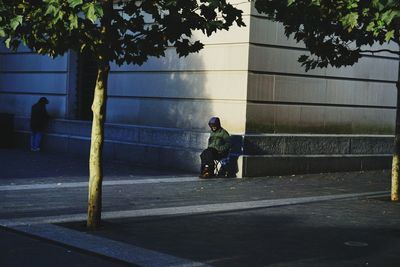 Man riding bicycle on road in city