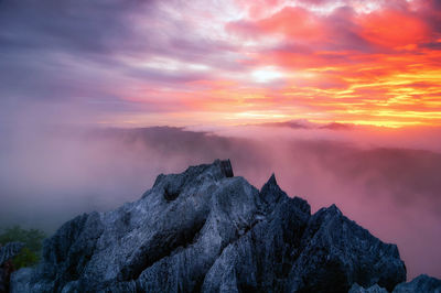 Aerial view rock of morning scenery golden light sunrise and the mist flows on high mountains, 