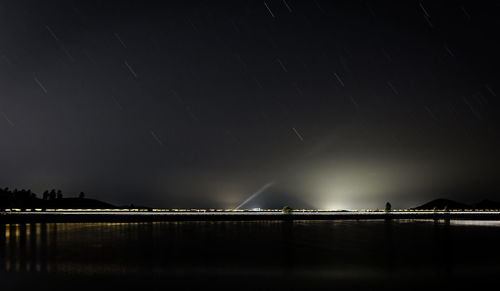 Low angle view of illuminated suspension bridge at night