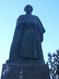 Low angle view of statue against clear blue sky