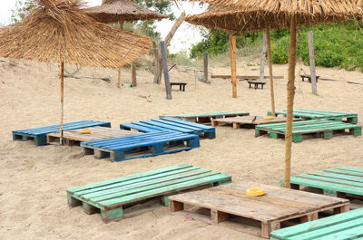 Chairs and tables on sand at beach