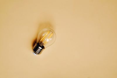 Close-up of light bulb on wall
