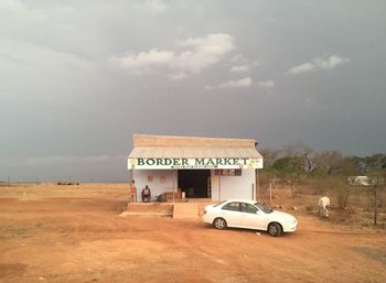 Information sign on car against sky