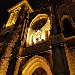 Low angle view of illuminated cathedral against sky at night