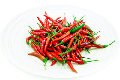 High angle view of red chili peppers over white background