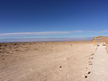 Scenic view of beach against blue sky