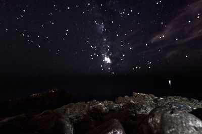 Scenic view of illuminated mountains against sky at night