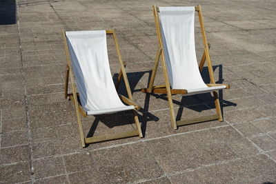 High angle view of empty chair on tiled floor