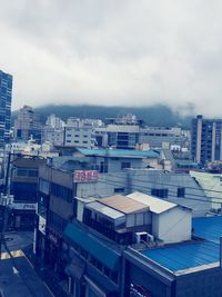 Buildings against cloudy sky