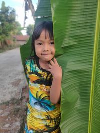 Portrait of smiling girl standing outdoors