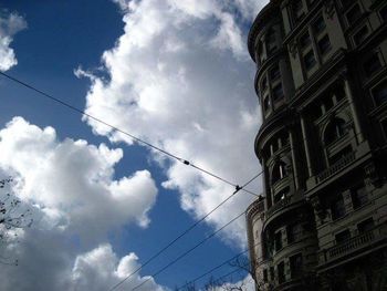 Low angle view of building against cloudy sky