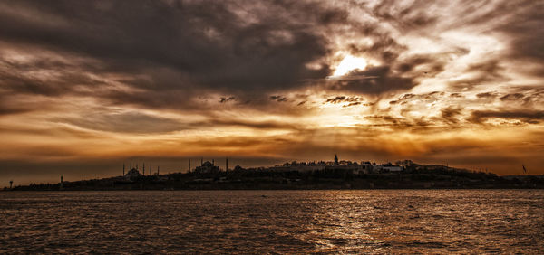 View of buildings against cloudy sky during sunset