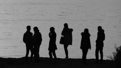 Silhouette of people standing on ground