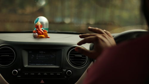 Close-up of person driving car