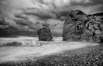 Rocks in sea against sky