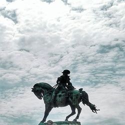 Statue of liberty against cloudy sky