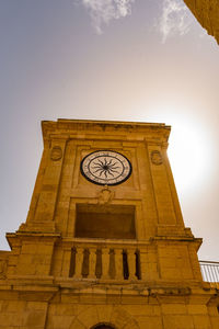 Low angle view of clock tower against sky