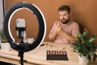 Portrait of young man working on table