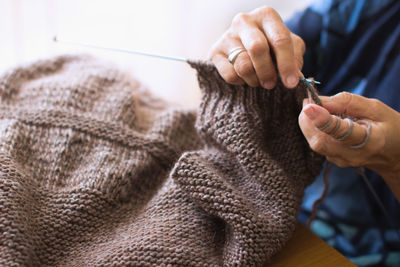 Cropped image of hands knitting wool