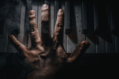 Close-up of person hand in dark room