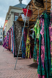 Low angle view of multi colored clothes on market in the city