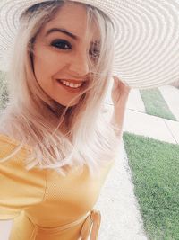 Portrait of smiling young woman wearing hat