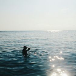 Silhouette woman in sea