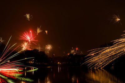 Low angle view of firework display against sky at night