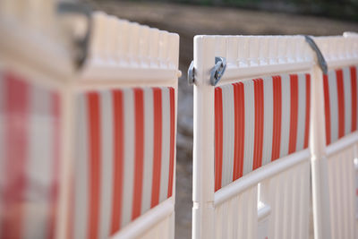 Close-up of hooded chairs on railing