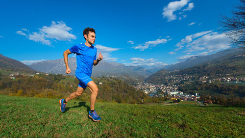 Full length of man running against sky