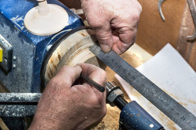 Cropped hands of carpenter working in workshop