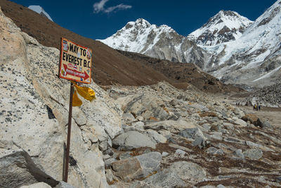 Information sign on rock against sky