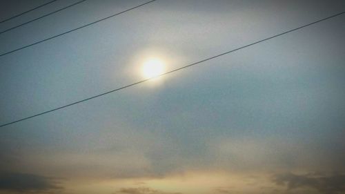 Low angle view of power lines against sky