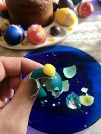 Close-up of hand holding multi colored candies