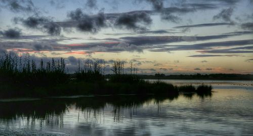 Scenic view of lake at sunset