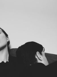 Portrait of woman sitting on wall at home