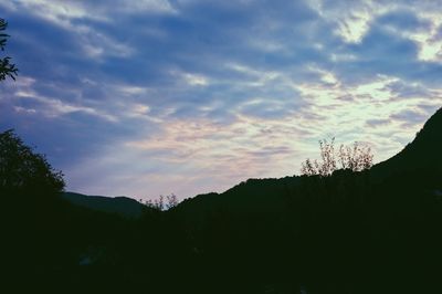 Scenic view of silhouette mountains against sky at sunset