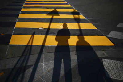High angle view of yellow shadow on street