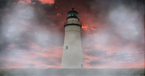 Low angle view of lighthouse against sky during sunset