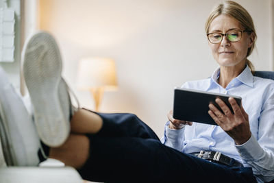 Businesswoman sitting down using tablet