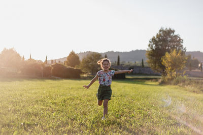 Rear view of man standing on field against clear sky