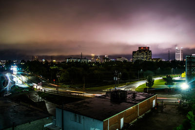 High angle view of illuminated buildings against sky at night