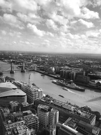 High angle view of river amidst buildings in city against sky